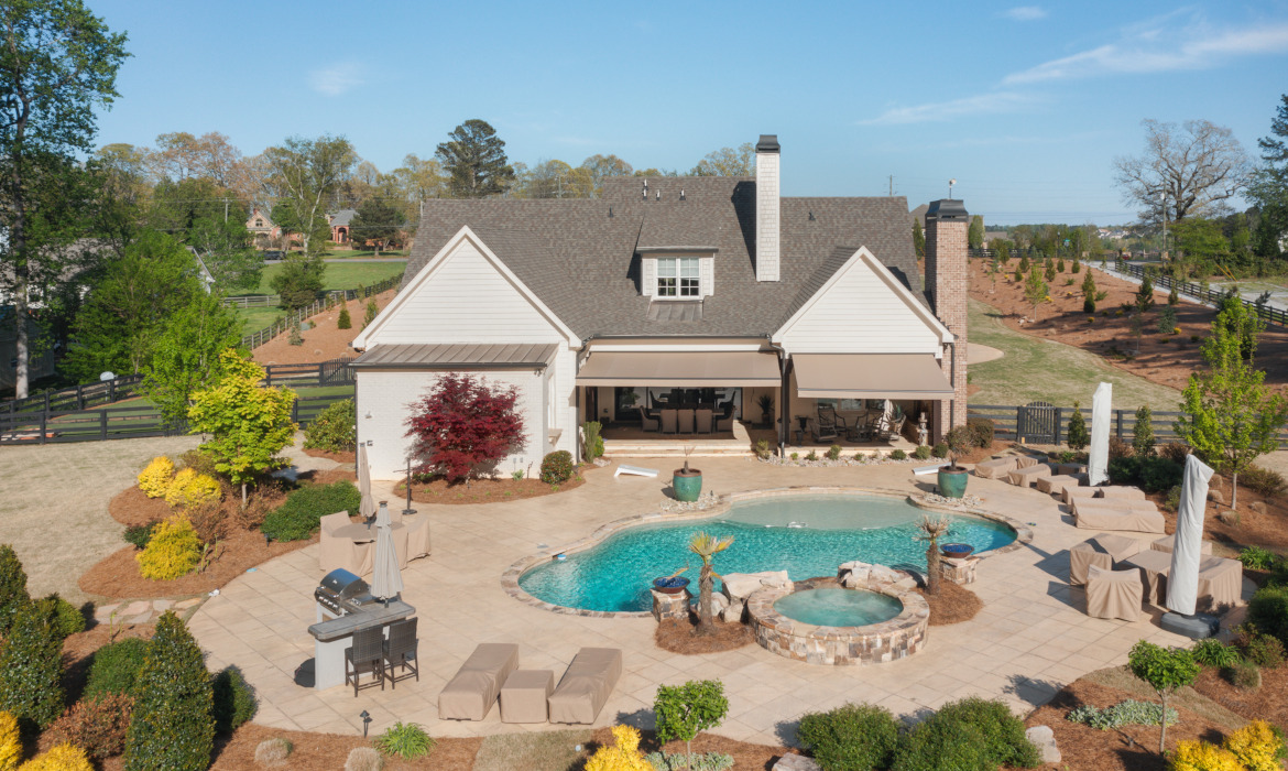 House with two awnings extended over pool area