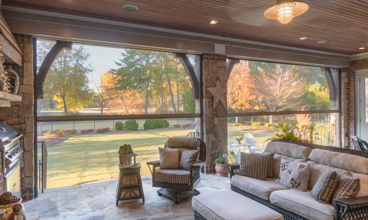 looking past retractable screens from porch into backyard