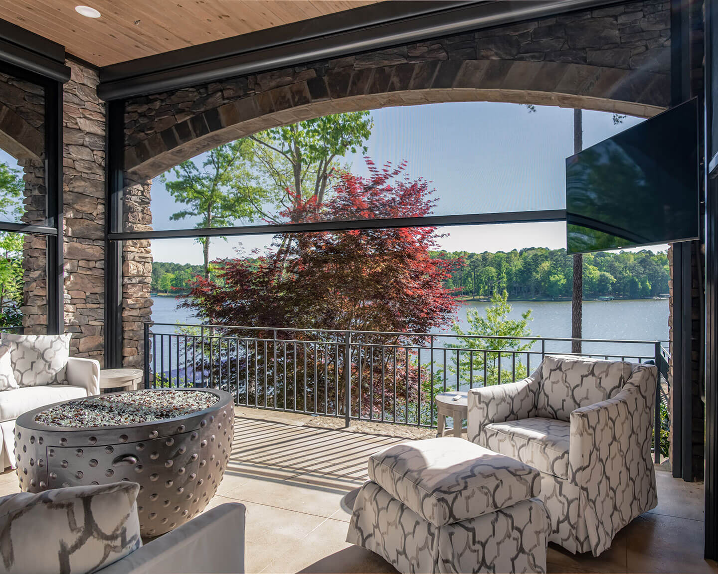 Motorized retractable screens lowered across a covered residential porch