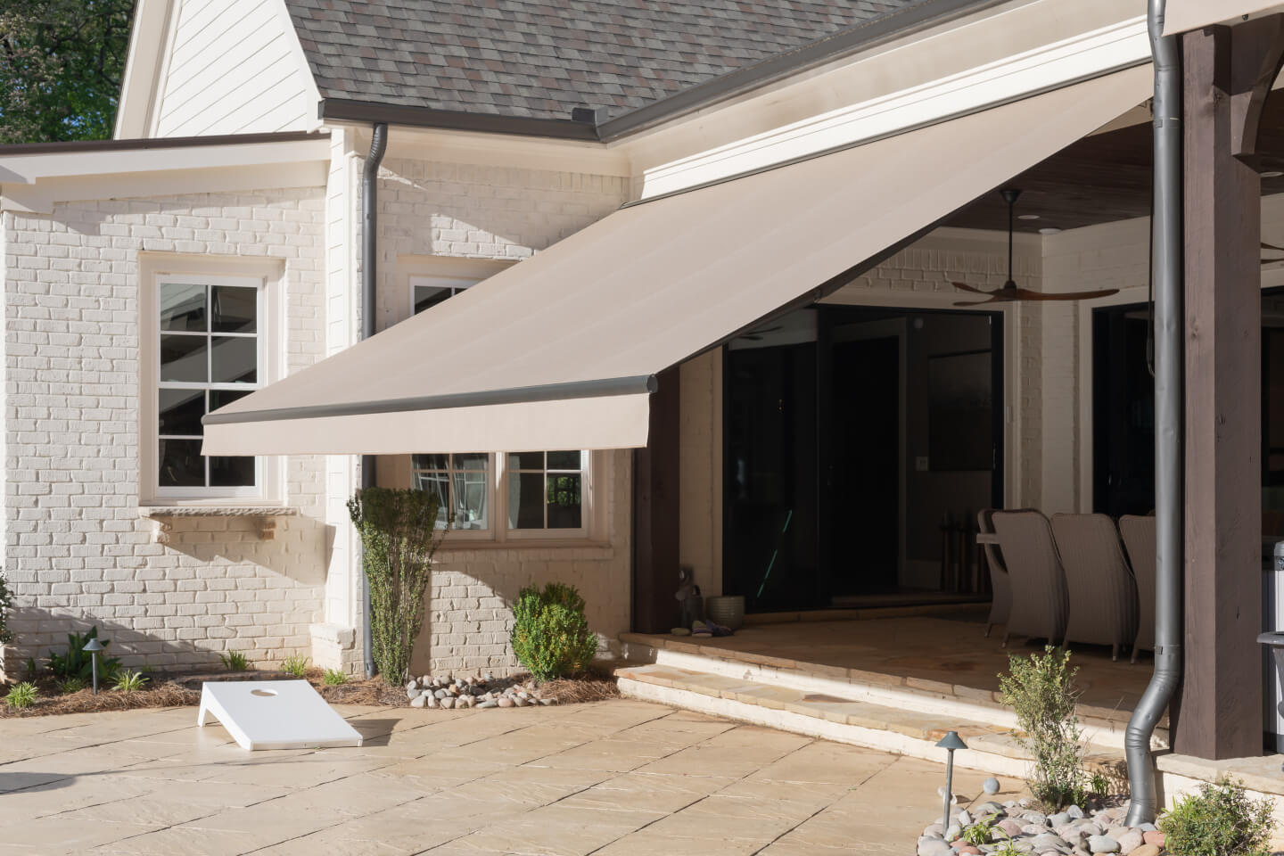 Retractable patio awning mounted above a home terrace