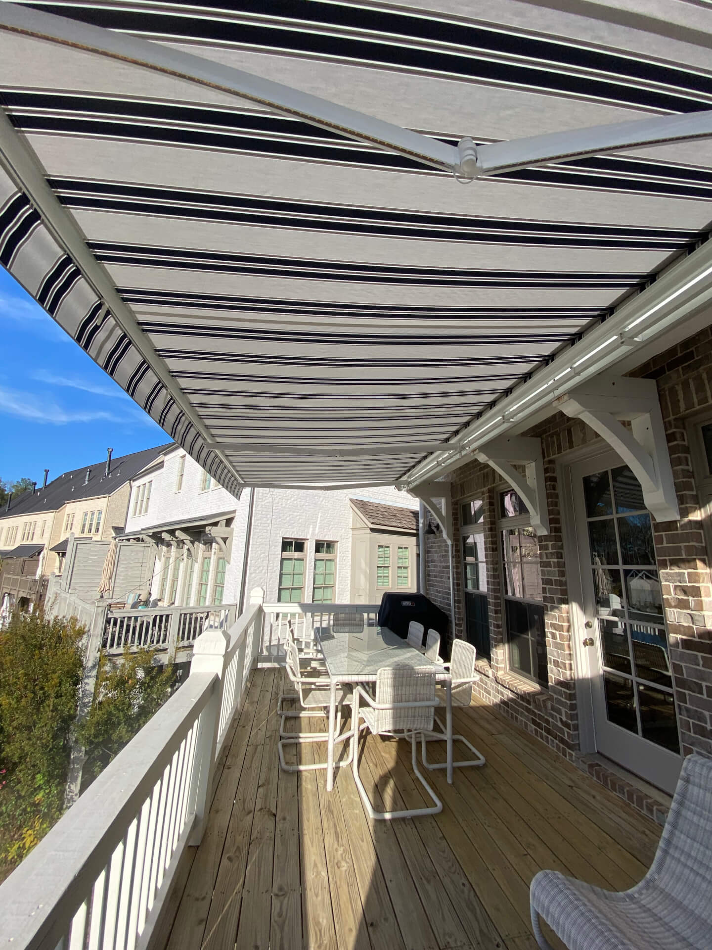 Striped retractable awning extended over a residential balcony