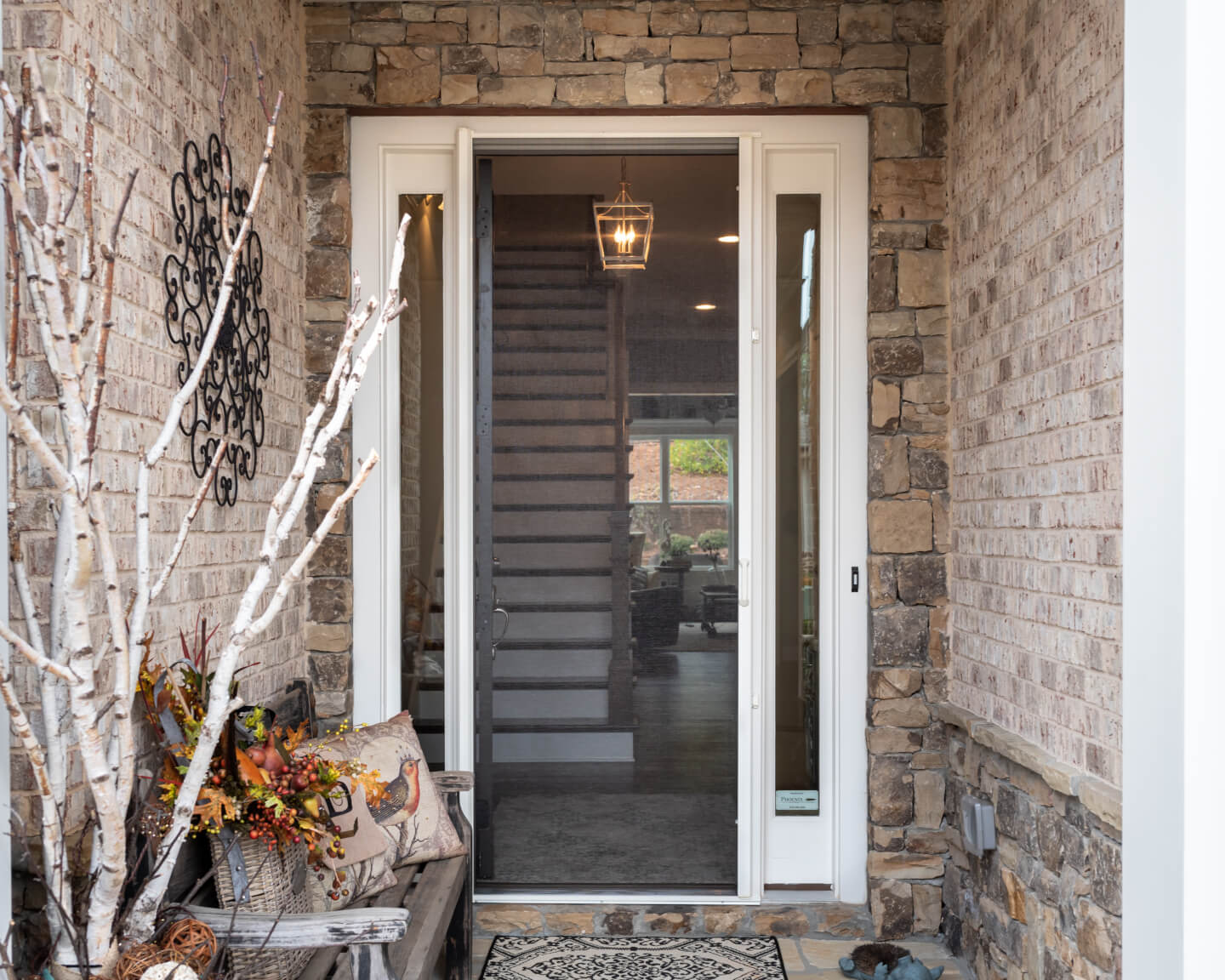 Retractable screen installed on a stone exterior doorway