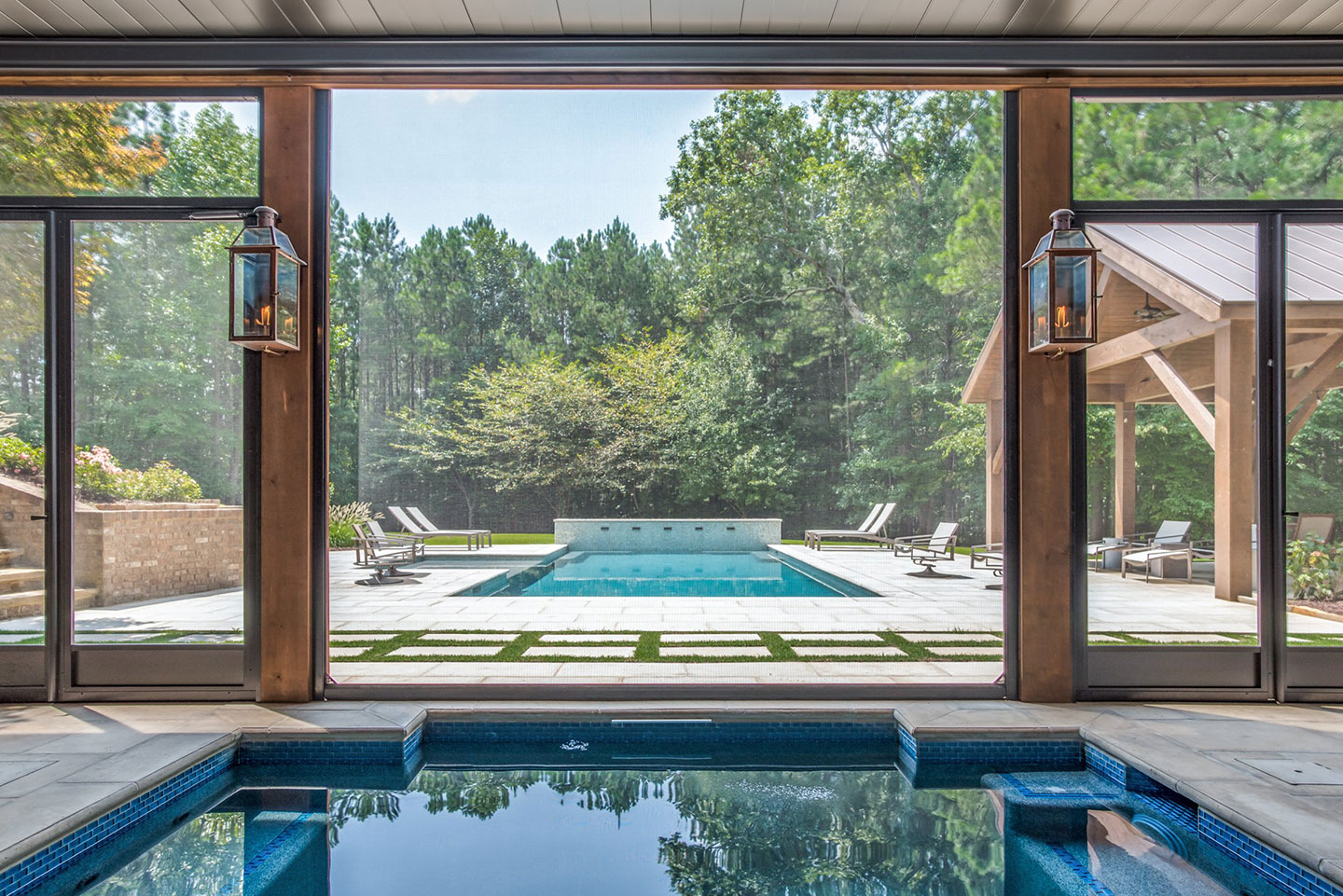 Retractable door screen opening onto a residential pool area