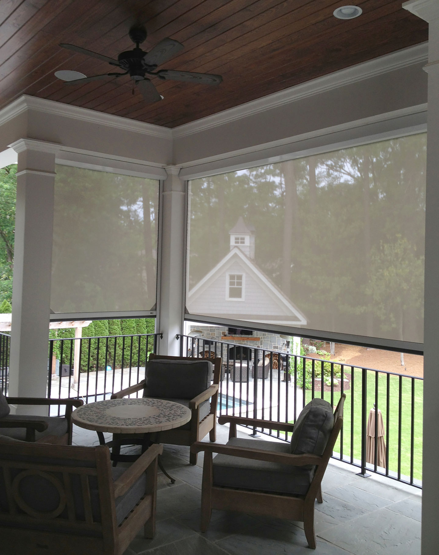 Outdoor solar shade installed across a residential patio opening