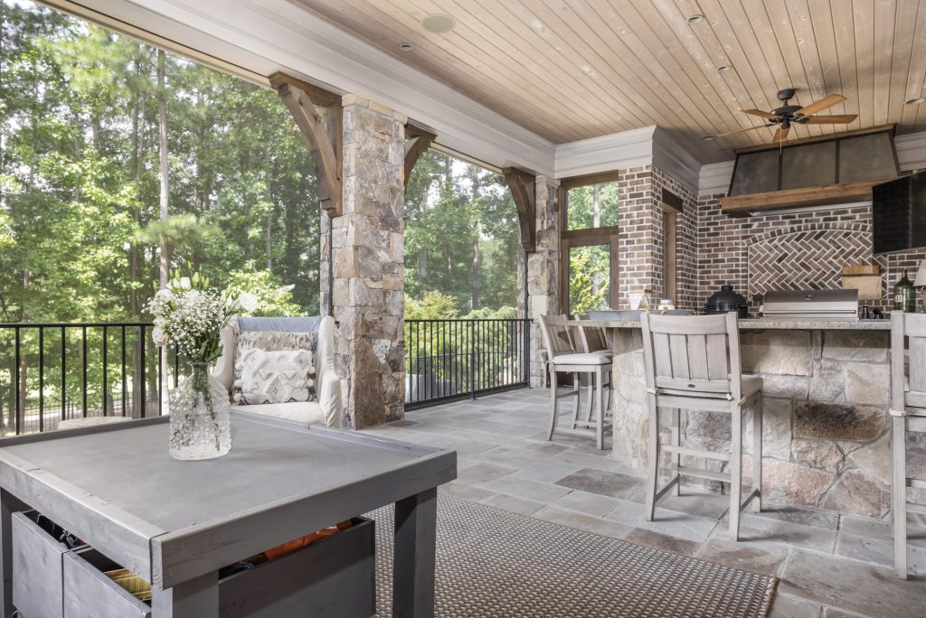 Outdoor porch with elaborate brick and stonework and retractable screens.